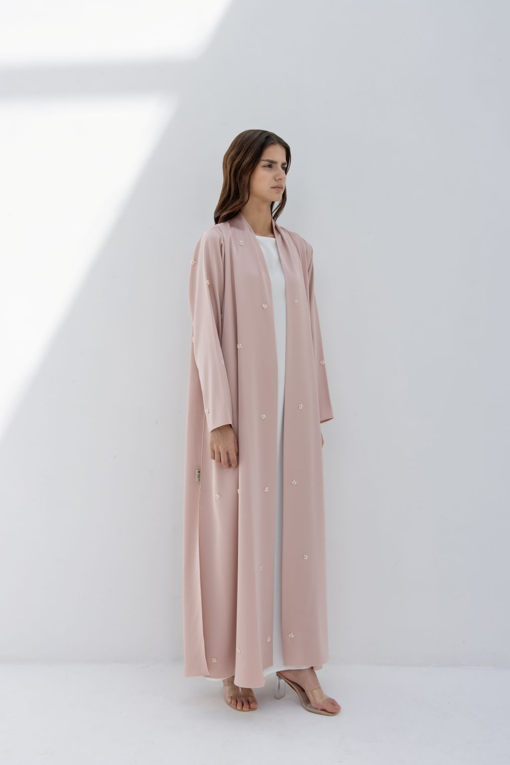 Selected Lines luxury fashion abaya in soft pink with delicate pearl embellishments worn by model