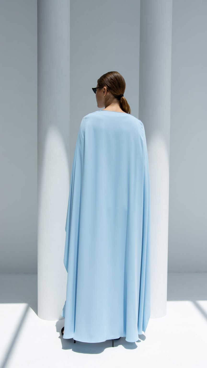 Elegant luxury Noura Abaya in light blue, showcasing a smooth flow and modern design
