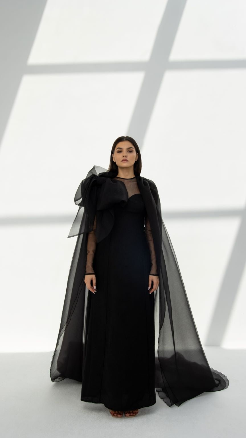 Elegant black luxury organza abaya with sheer sleeves and dramatic bow detail by Selected Lines