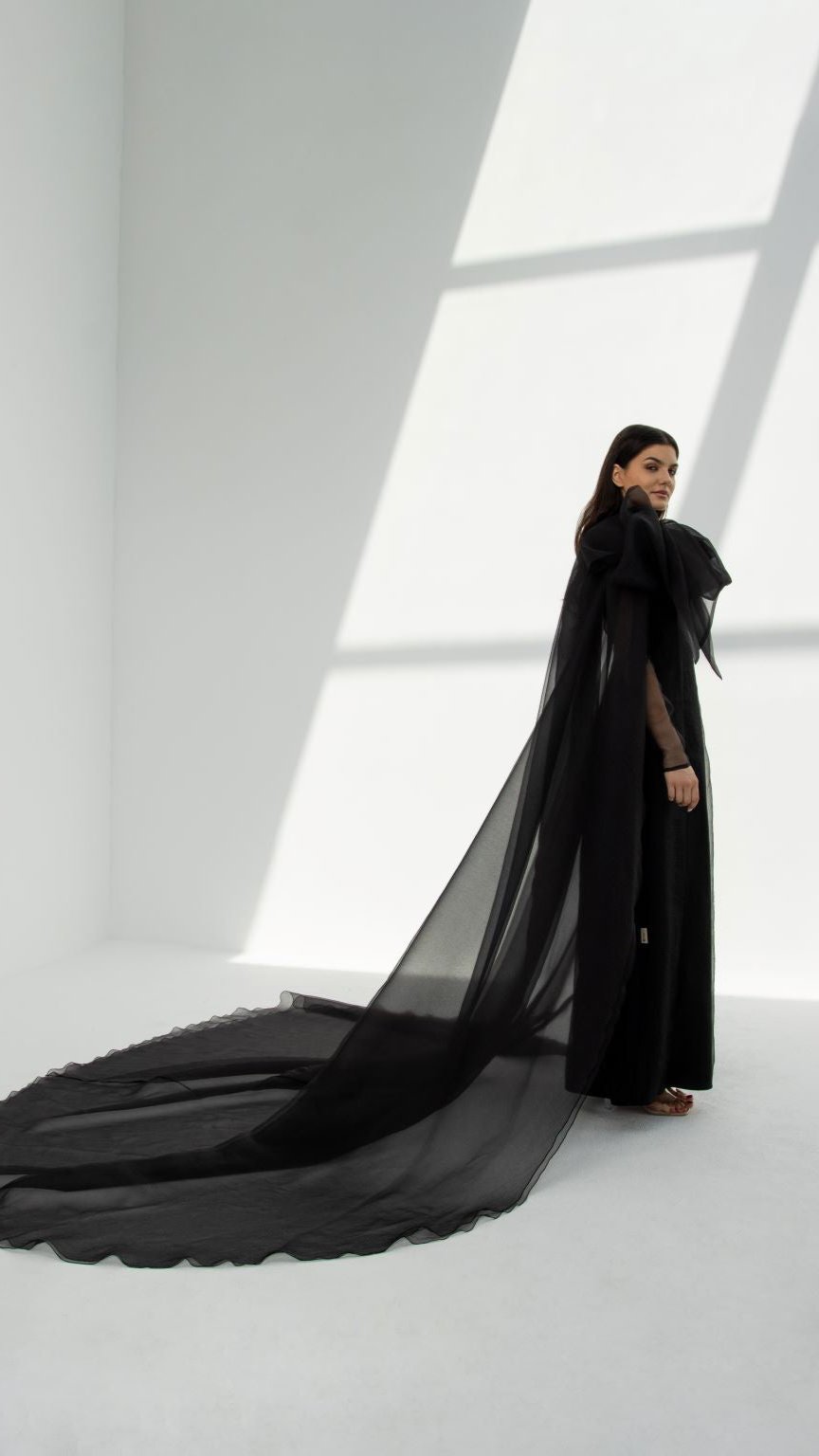Elegant luxury organza abaya in black with long flowing train and sheer fabric by Selected Lines