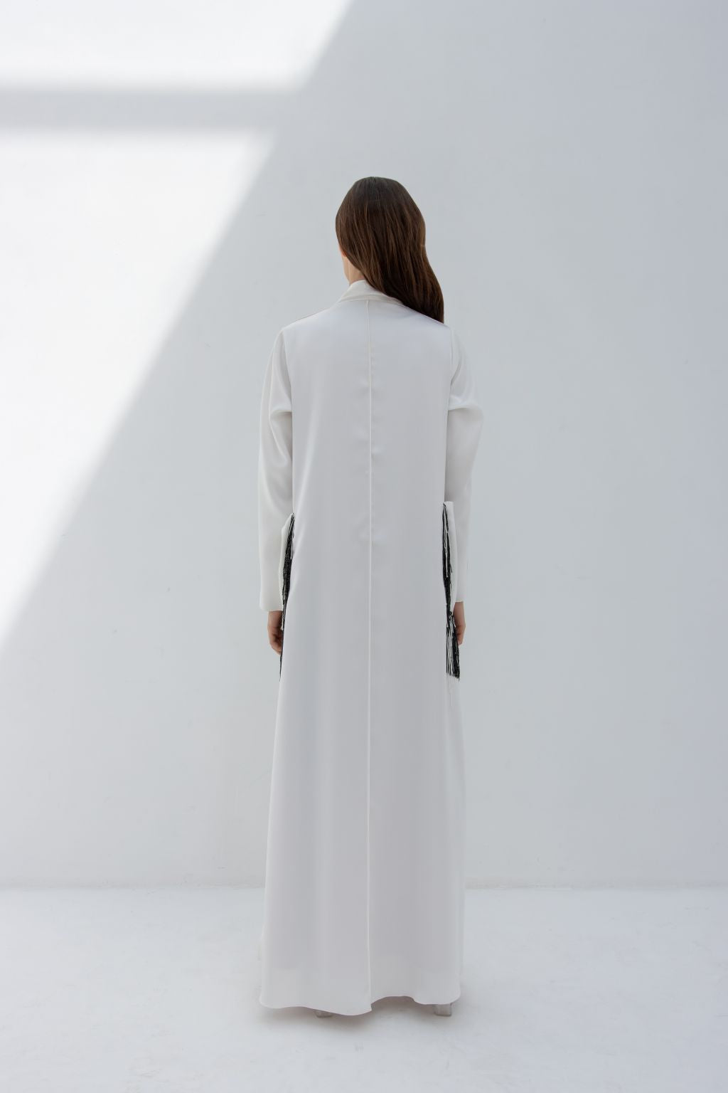 Selected Lines luxury pocket tassel abaya in white with long sleeves and back view