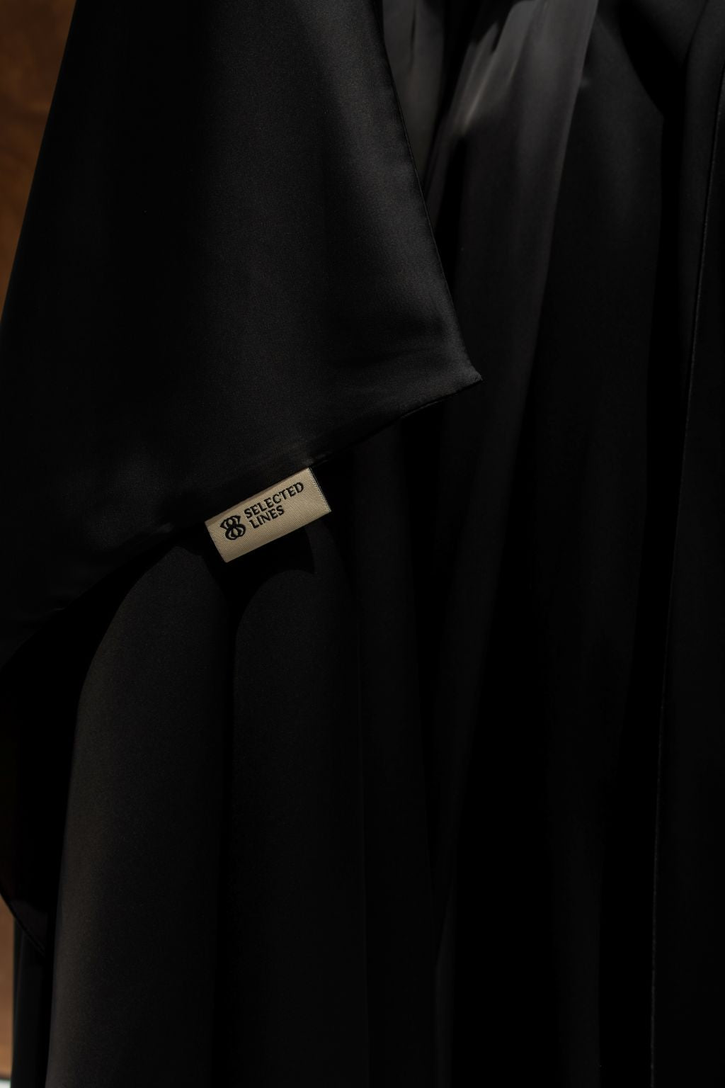 Elegant luxury silk abaya in black from Selected Lines with a smooth, flowing design