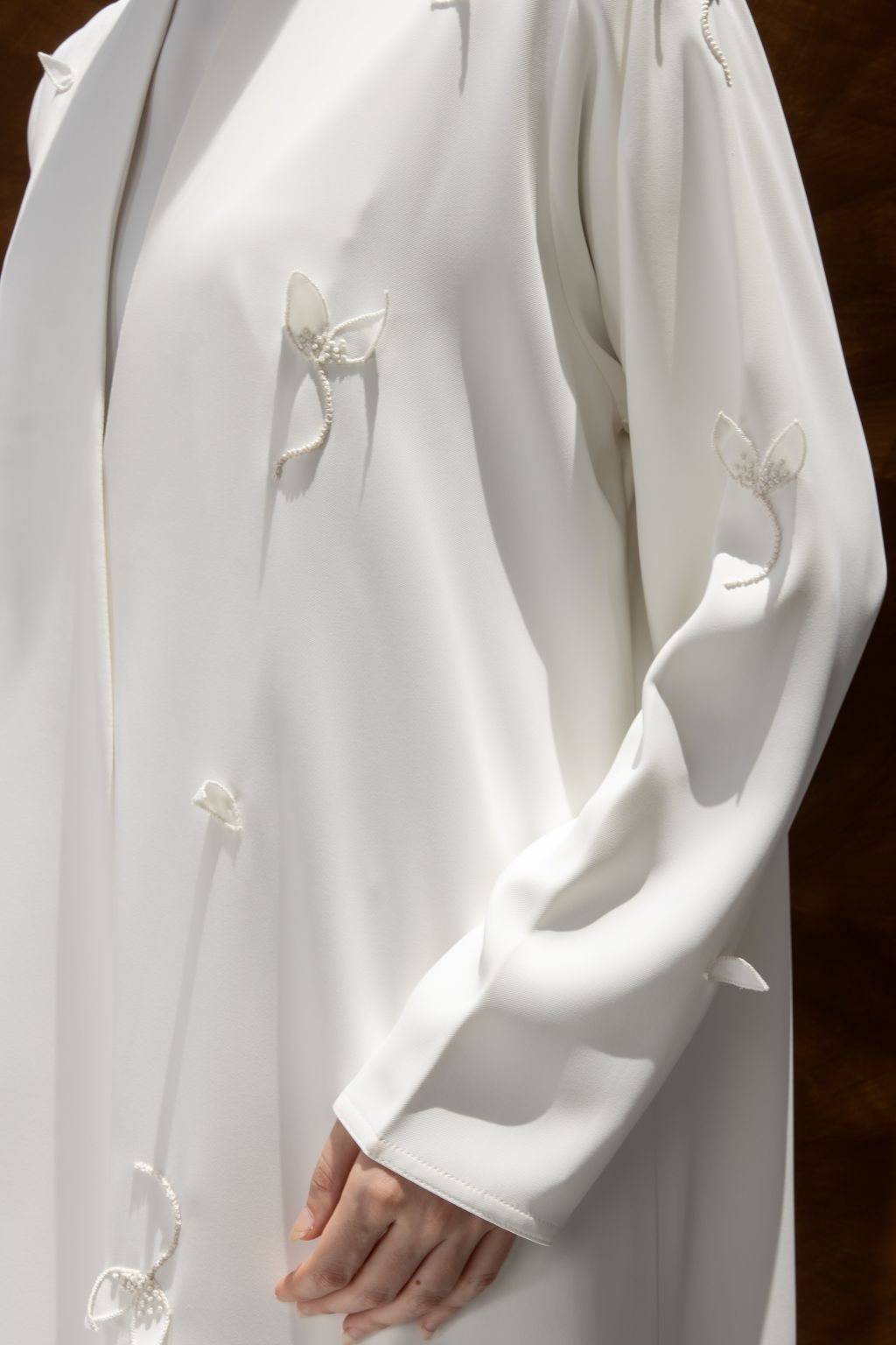 Selected Lines luxury white abaya dress with delicate floral embroidery on sleeve and front