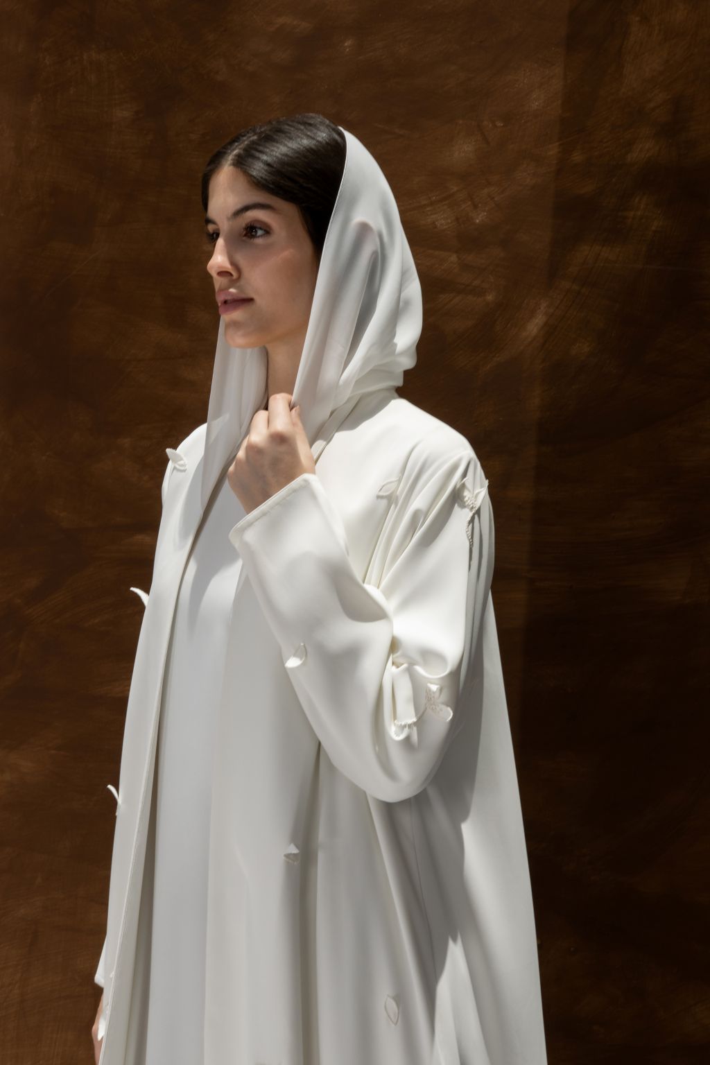 Selected Lines luxury white abaya dress with hooded design and elegant draped sleeves