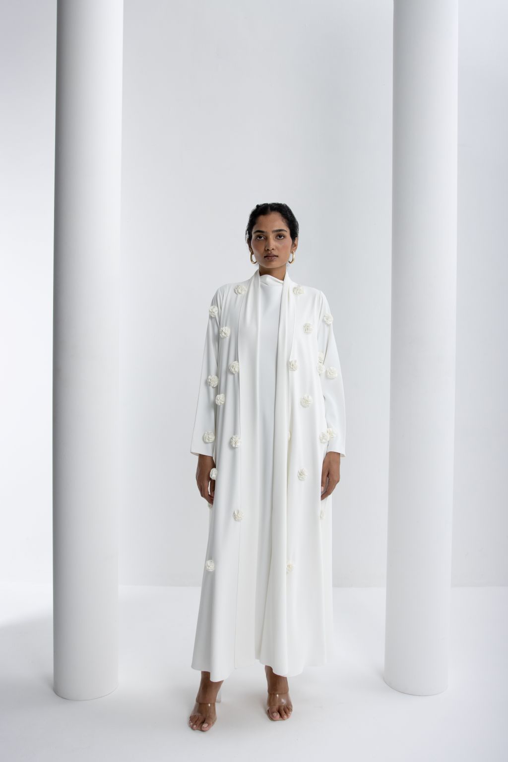 Luxury white abaya with rose embroidery, featuring a minimalist design and elegant silhouette