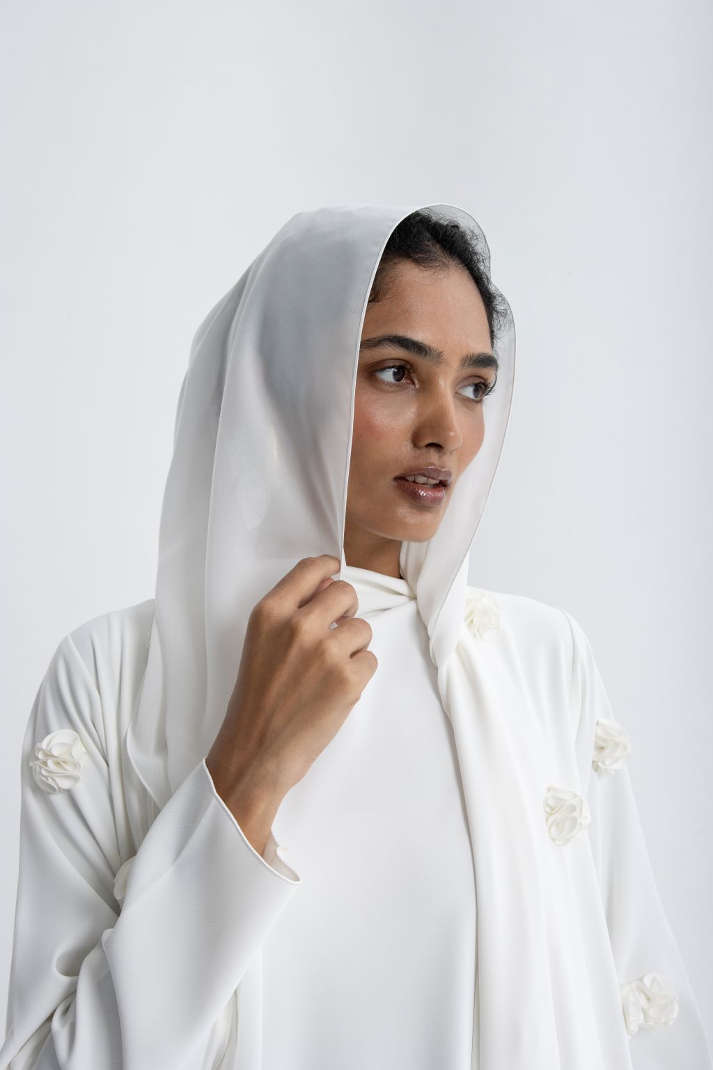 Elegant luxury white abaya with rose embroidery, featuring a hood and floral details