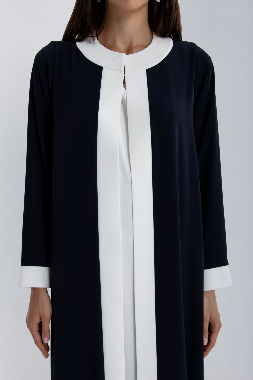 Elegant luxury women's abaya in navy blue with white accents and long sleeves