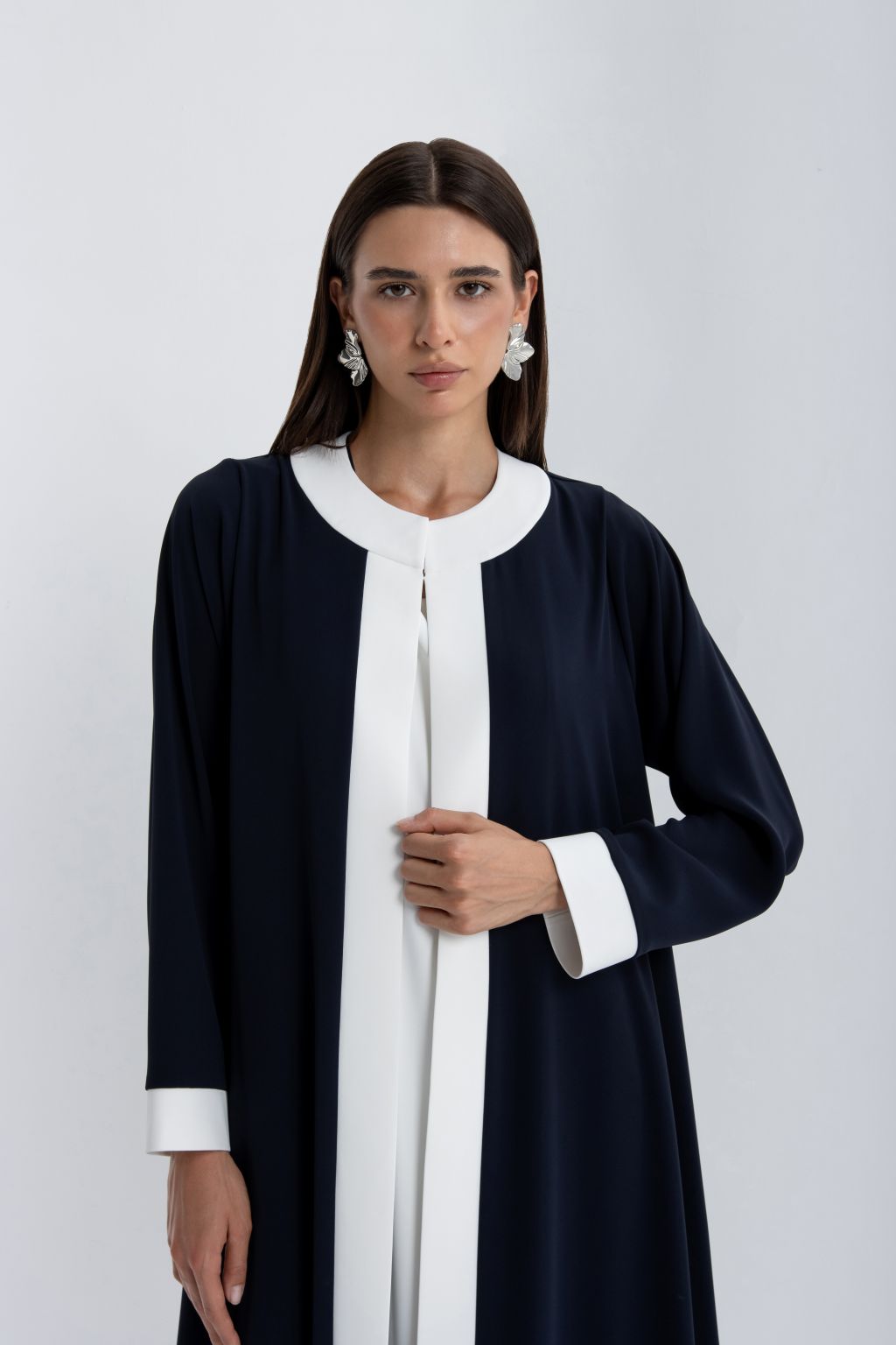 Elegant luxury women's abaya in navy blue with white accents and a classic silhouette
