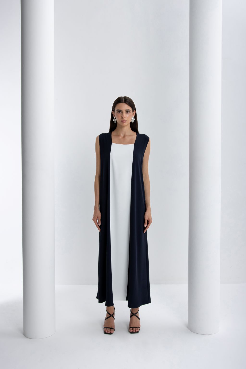Elegant luxury women's abaya featuring a navy outer layer over a white inner dress