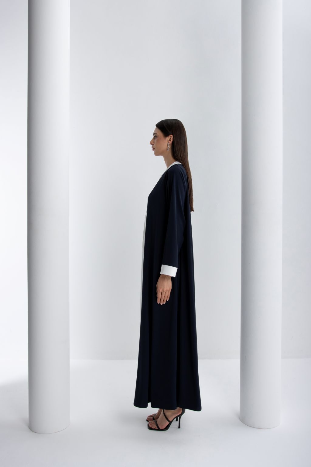 Luxury women's abaya in navy blue with elegant white cuffs, perfect for stylish occasions