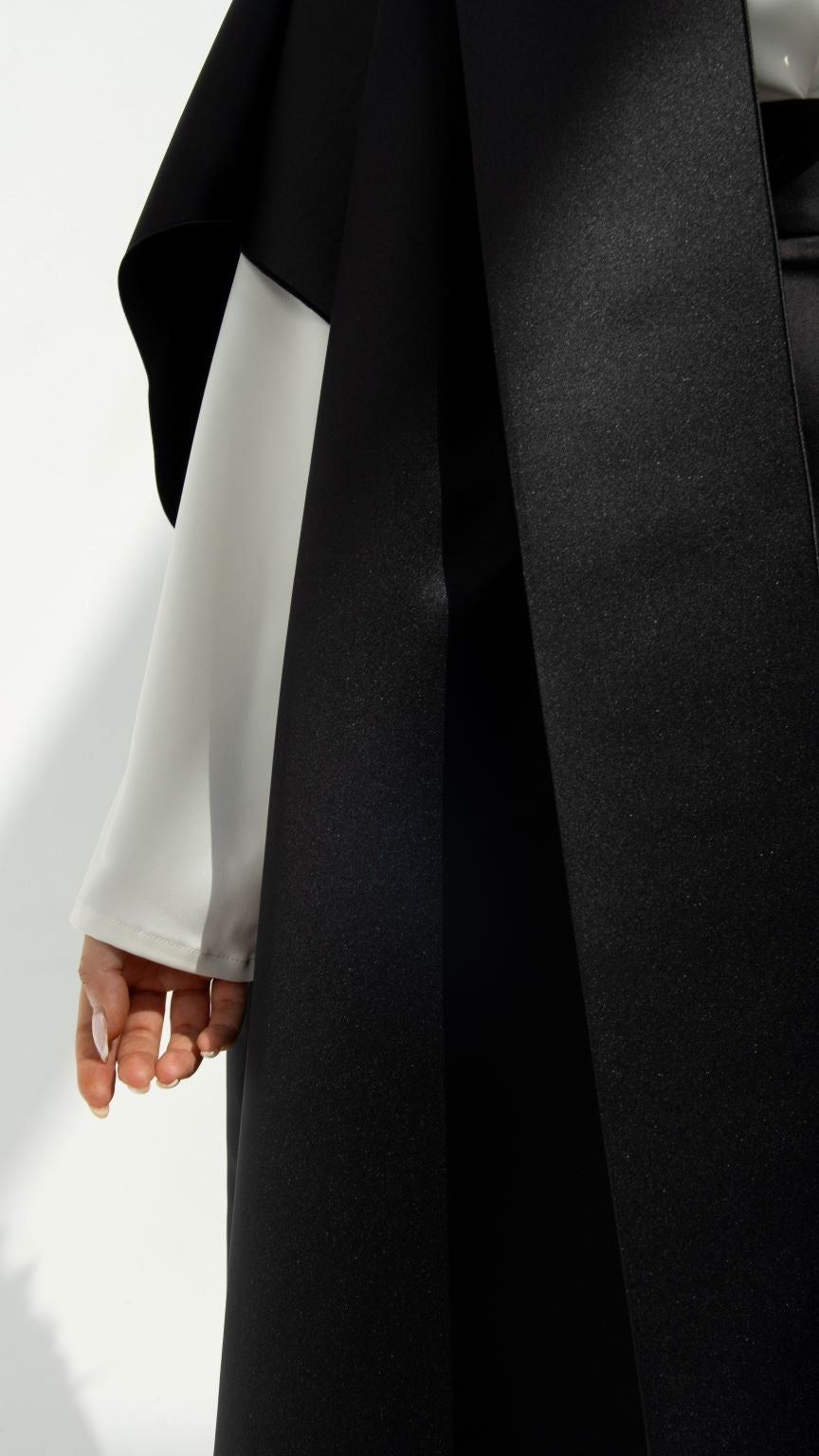 Selected Lines luxury yoga abaya with smooth black fabric layered over white sleeve detail