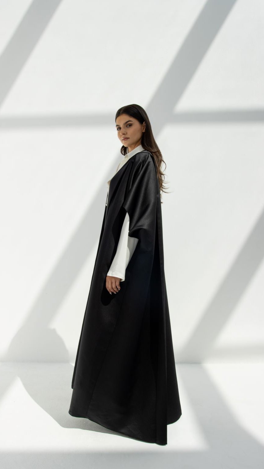 Selected Lines luxury yoga abaya in black worn by woman standing in natural light
