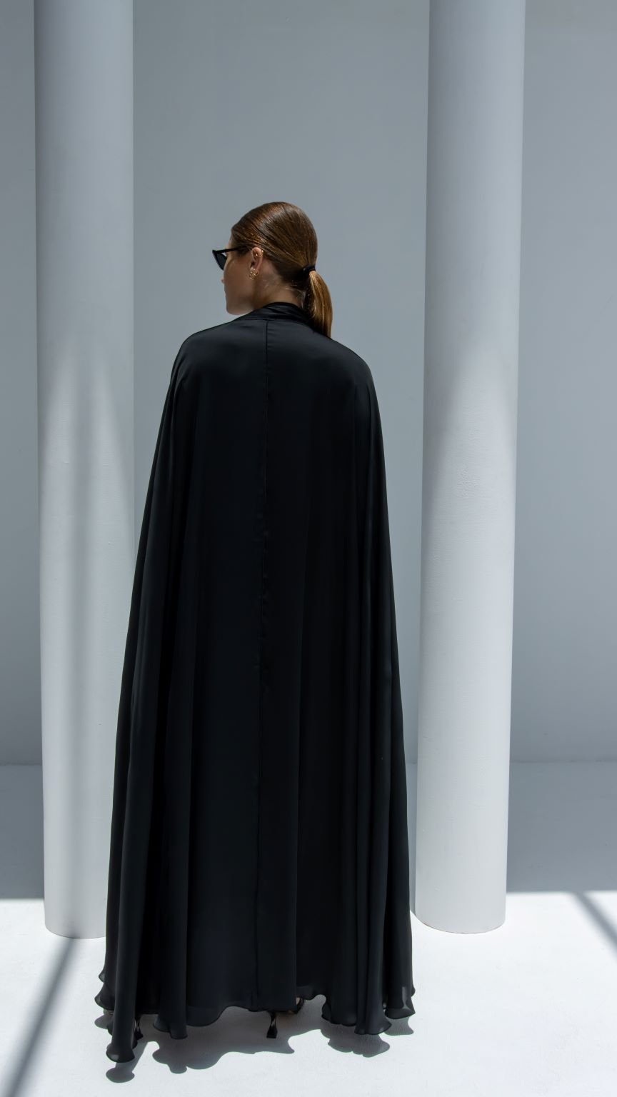 Back view of Mermaid Abaya showcasing elegant silhouette and luxurious black silk fabric | Selected Lines