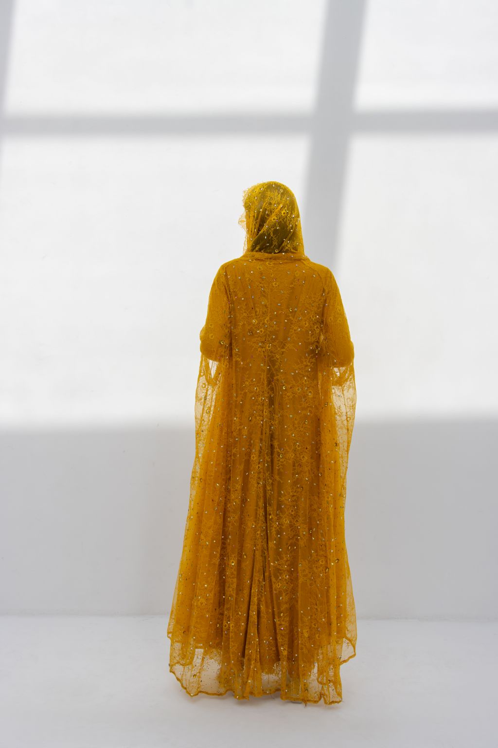 Back view of Munera Abaya highlighting sleek design in mustard dantel | Selected Lines