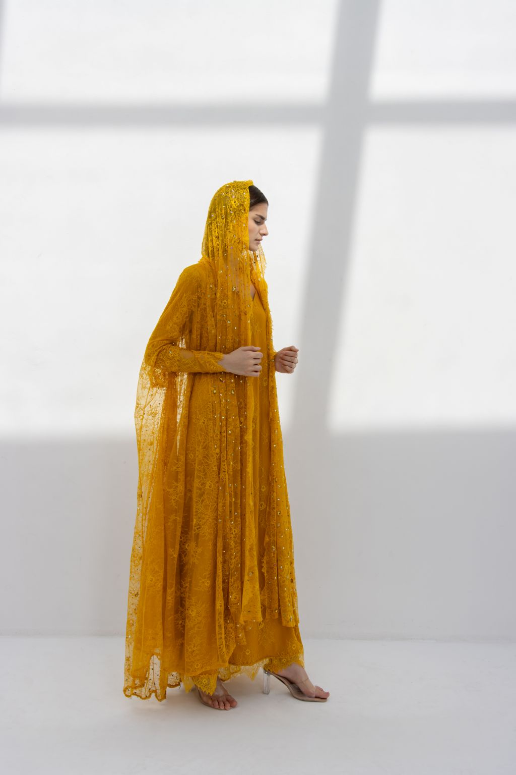 Side profile of Munera Abaya showcasing A-line fit and mustard dantel material | Selected Lines