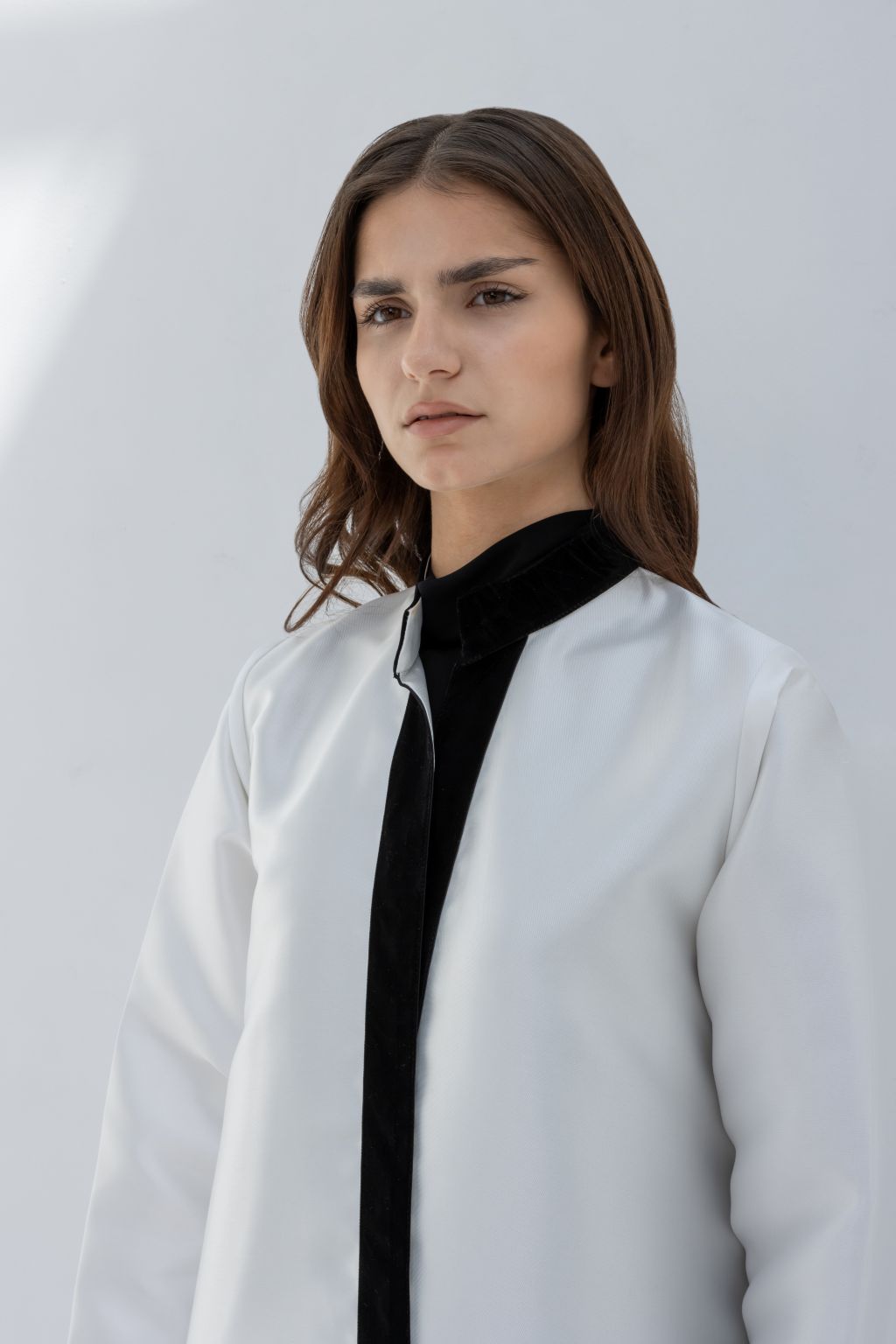 Selected Lines white abaya with black collar detail showcasing Nka Design luxury fashion