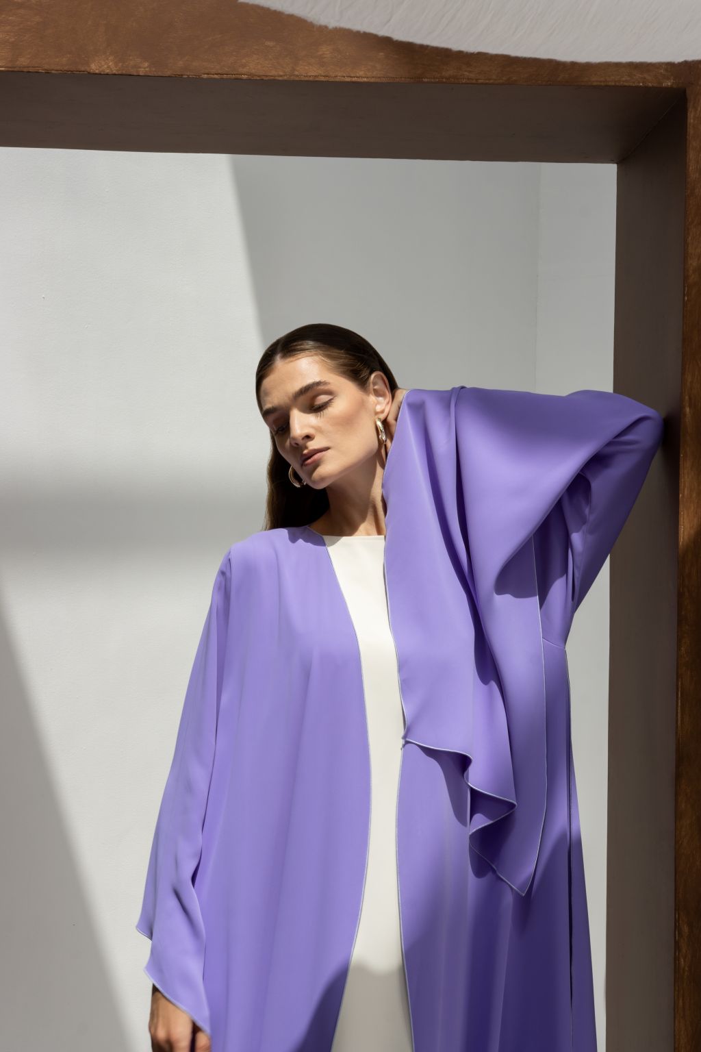 Woman wearing a lavender Onz SLC Signature robe by Selected Lines in minimalist bright setting