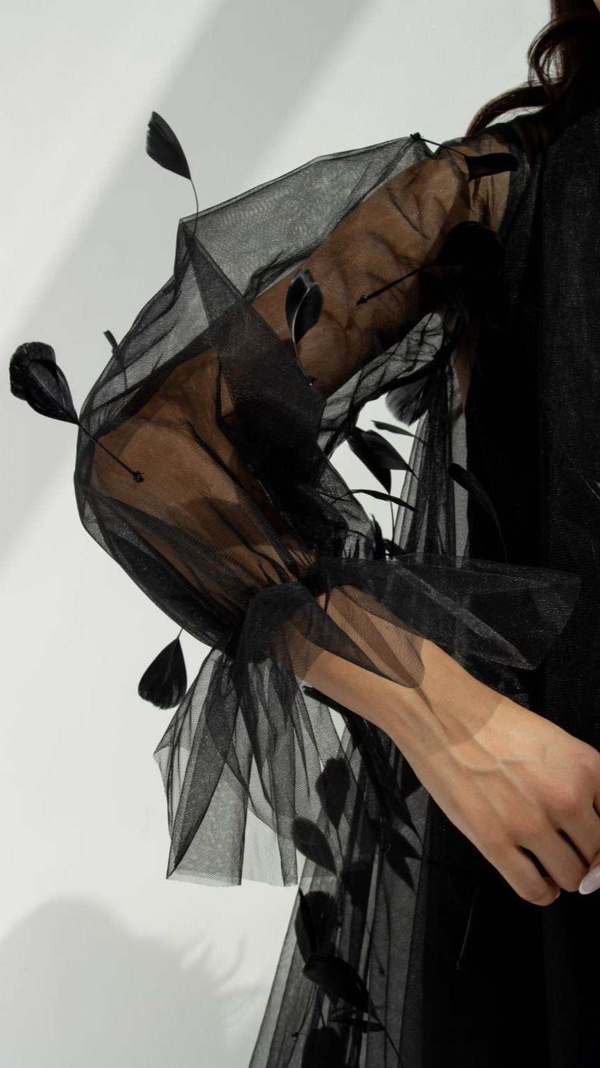Close-up of Plume Abaya’s intricate feather design on black tulle fabric | Selected Lines