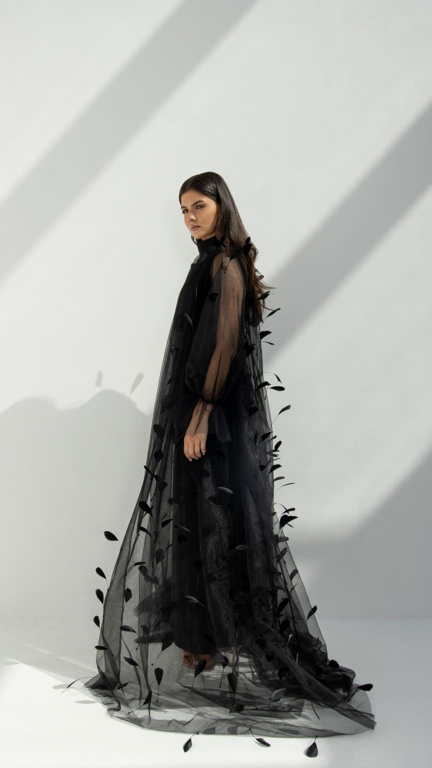 Side profile of Plume Abaya highlighting the flowing tulle fabric and feather accents | Selected Lines