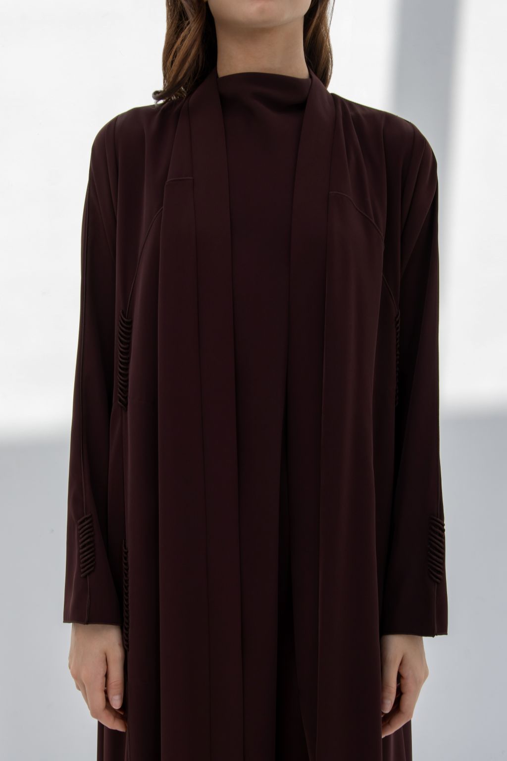 Elegant burgundy premium handcrafted abaya featuring long sleeves and a chic design.