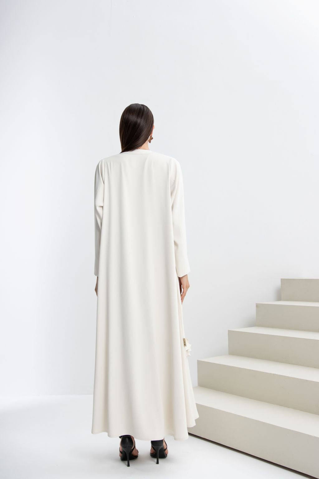 Elegant back view of a refined luxury evening abaya in soft white fabric, perfect for formal occasions