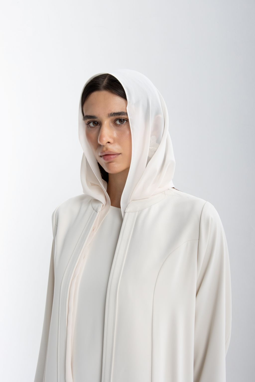 Elegantly designed refined luxury evening abaya in soft fabric with a matching hood