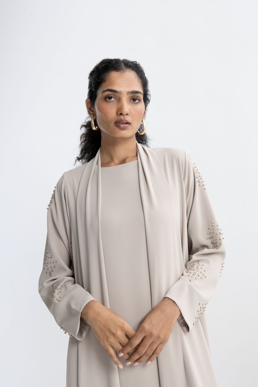 Refined neutral evening abaya with elegant detailing, perfect for sophisticated occasions