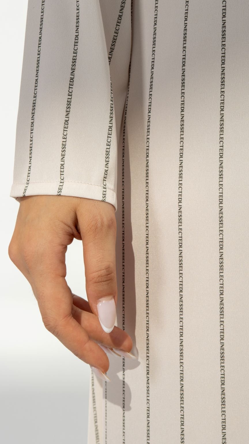 Close-up of SLC Signature Dress’s custom printed typing fabric and unique neckline design | Selected Lines