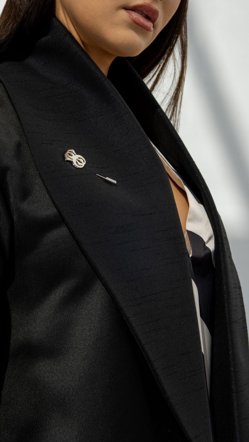 Close-up of Smart Abaya’s signature silver logo brooch and fabric texture | Selected Lines
