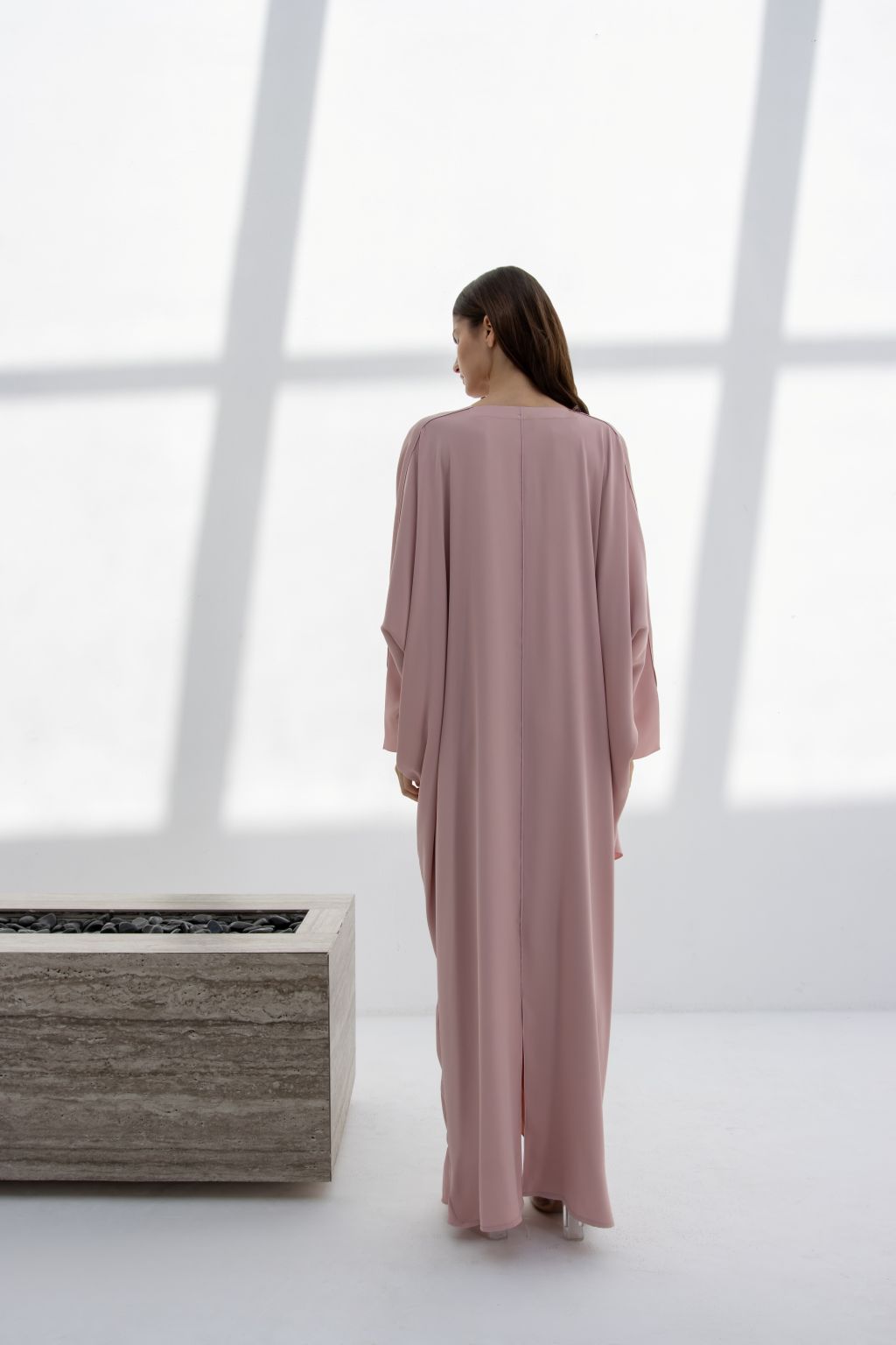 Elegant Selected Lines inner dress in soft pink, showcasing a timeless designer evening gown from the back