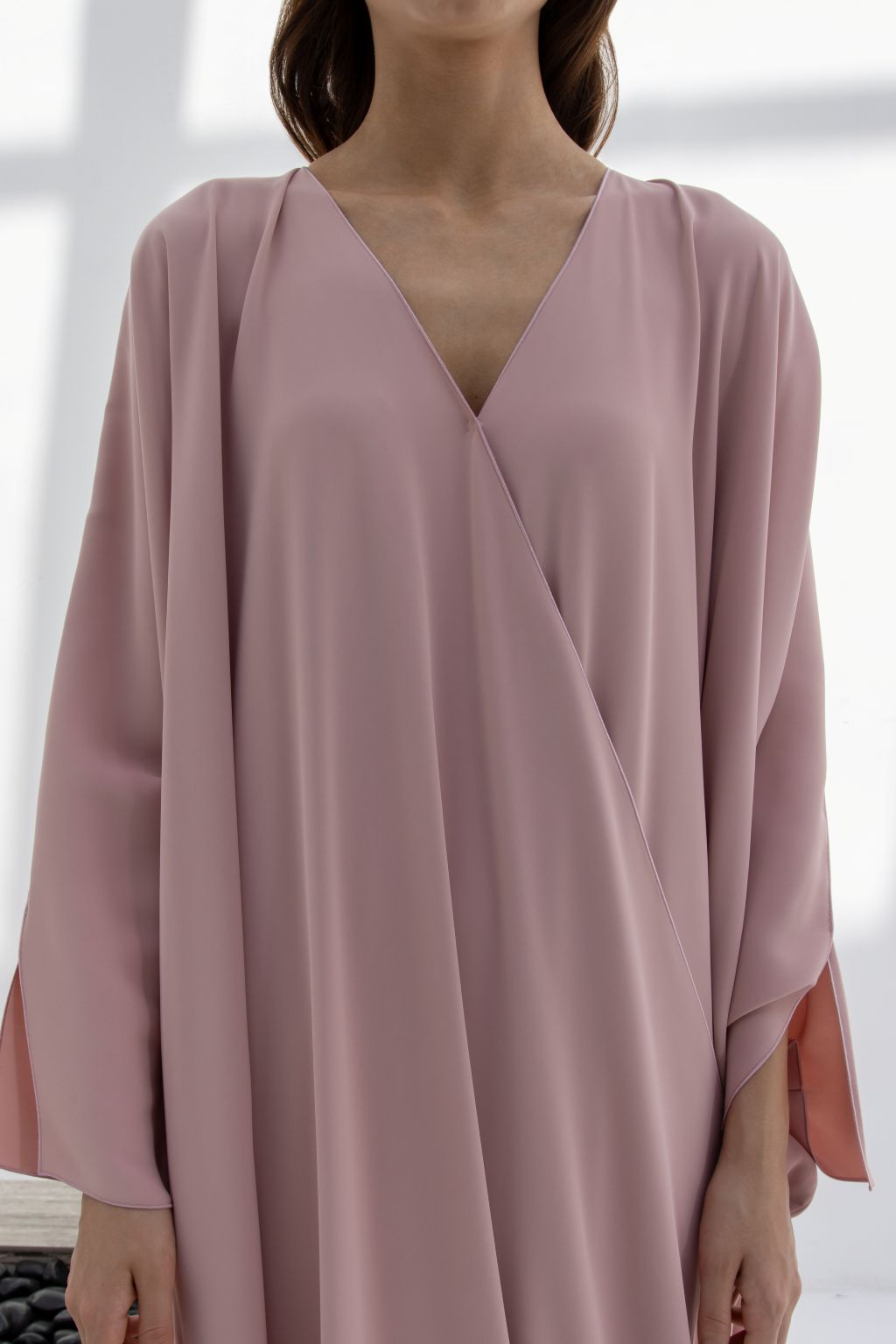 Selected Lines timeless designer evening gown in soft pink with a flattering V-neck and flowing sleeves