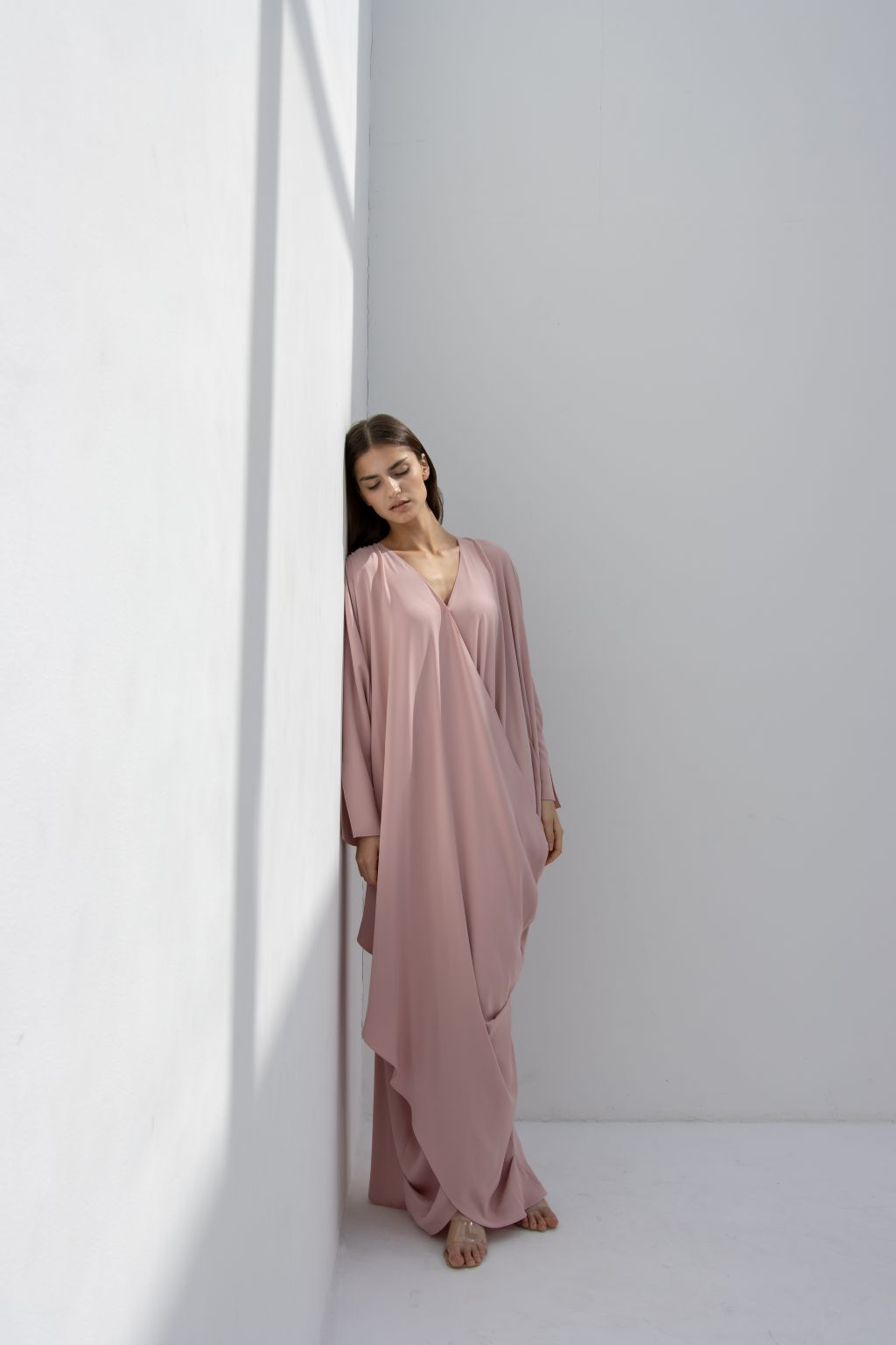 Selected Lines timeless designer evening gown in soft pink with elegant draping and long sleeves
