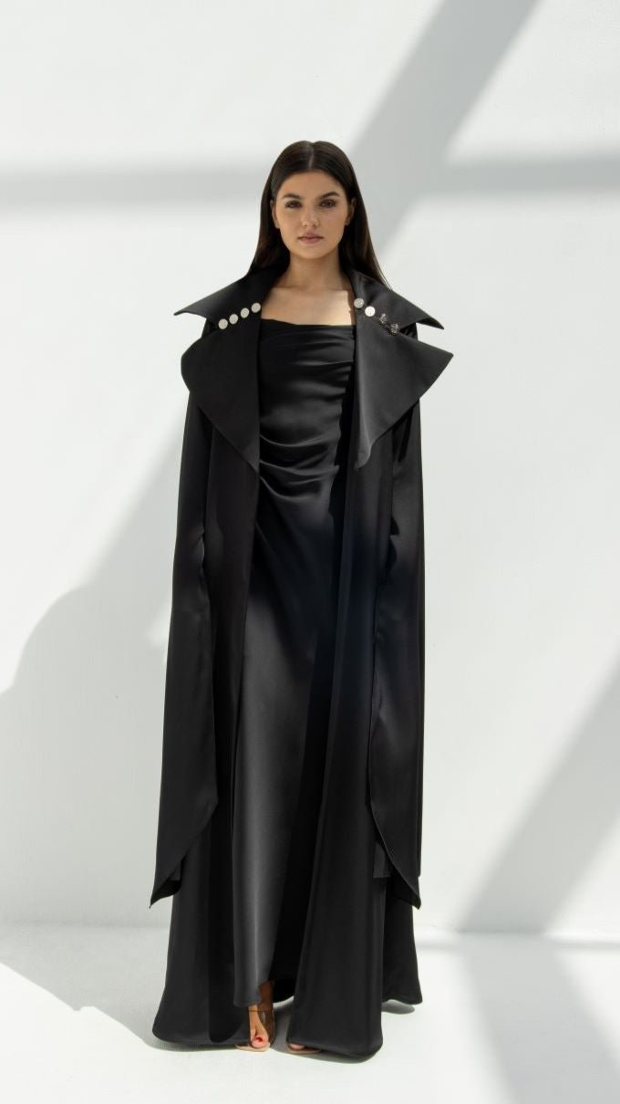 Selected Lines elegant abaya coat in black with wide collar and button details worn over a black dress