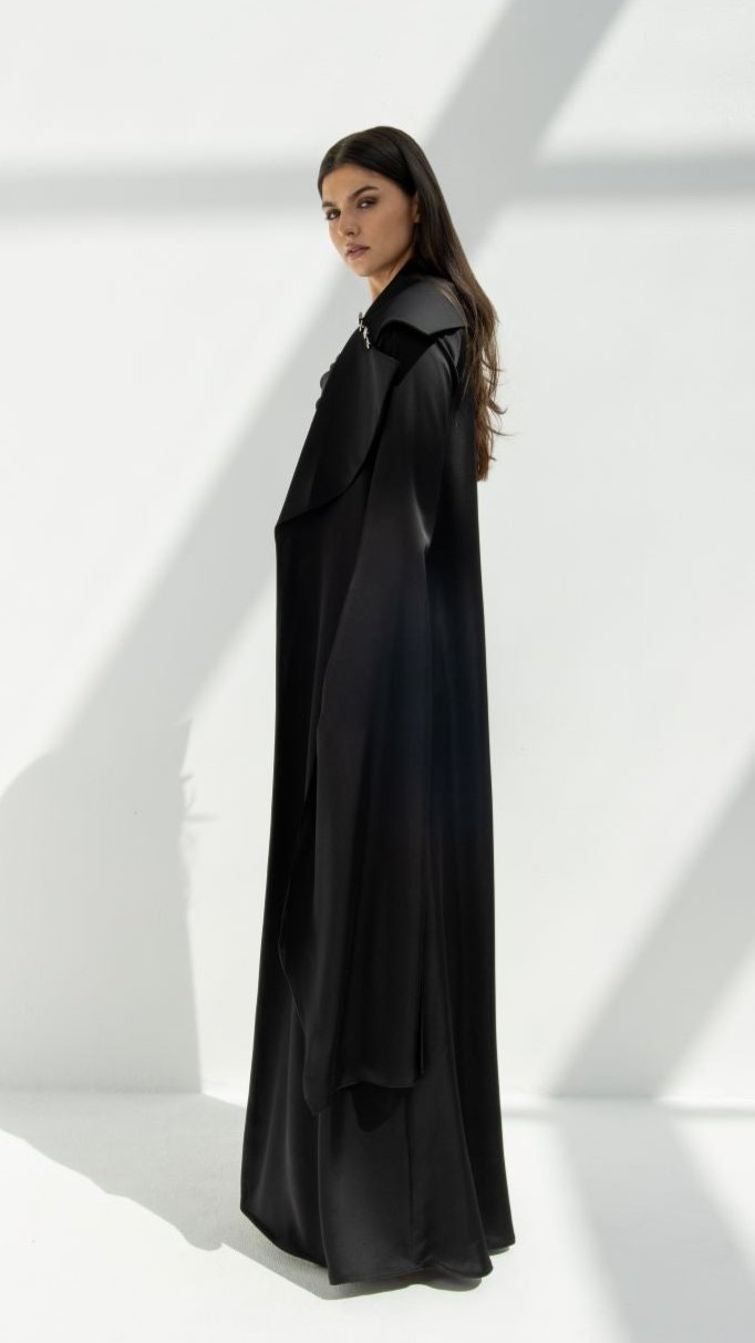 Selected Lines black elegant abaya coat worn by model with long sleeves and flowing design