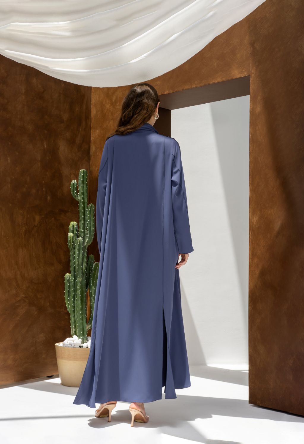 Selected Lines elegant long sleeve dress abaya in blue with a flowing design shown from the back