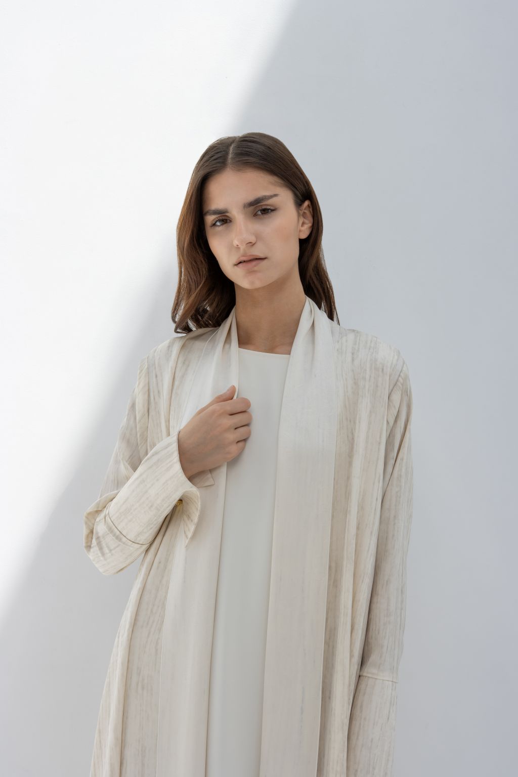 Selected Lines elegant printed abaya in soft neutral tones worn by a woman with long brown hair