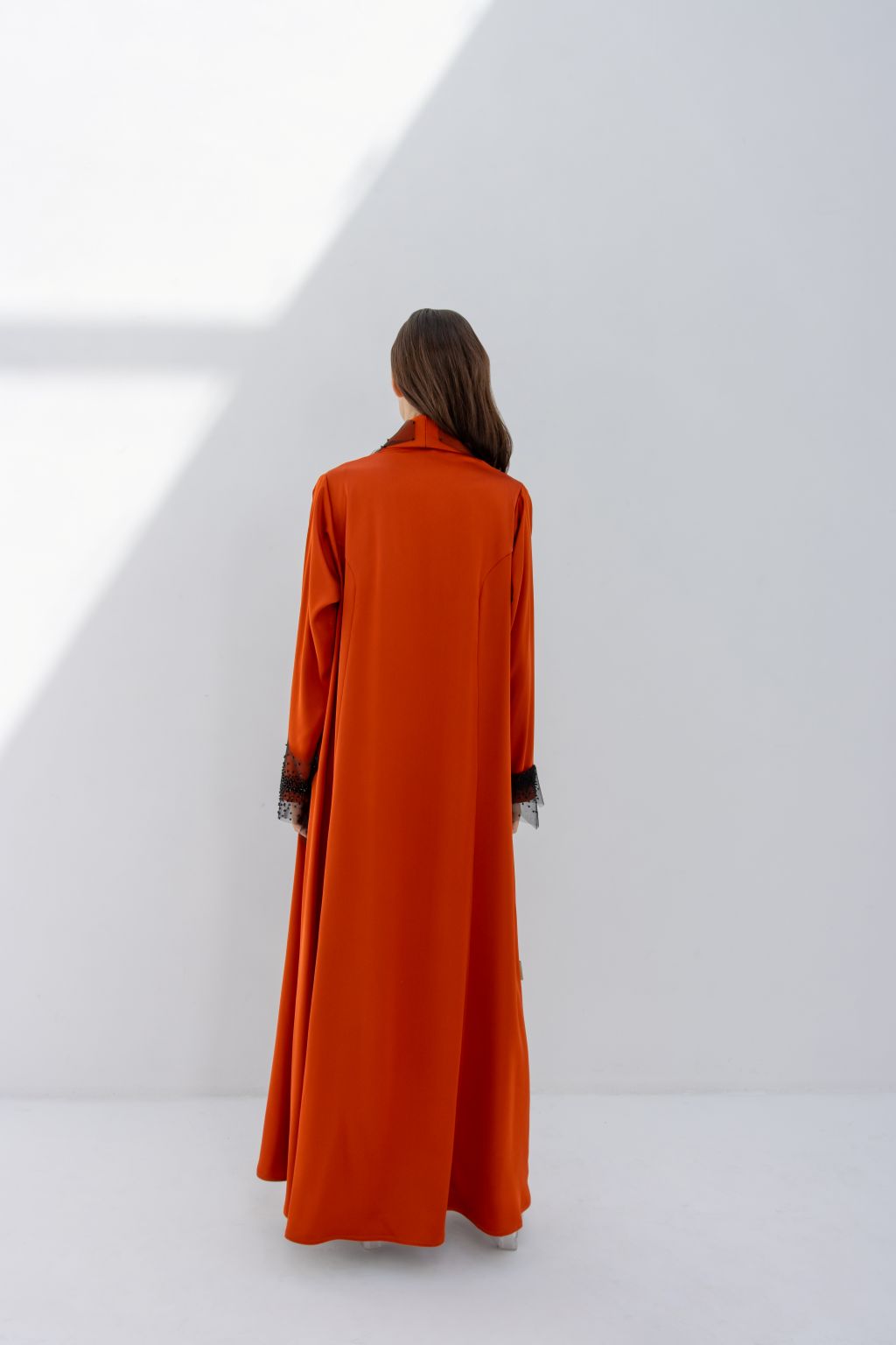 Selected Lines elegant tulle evening abaya in burnt orange shown from the back with long sleeves