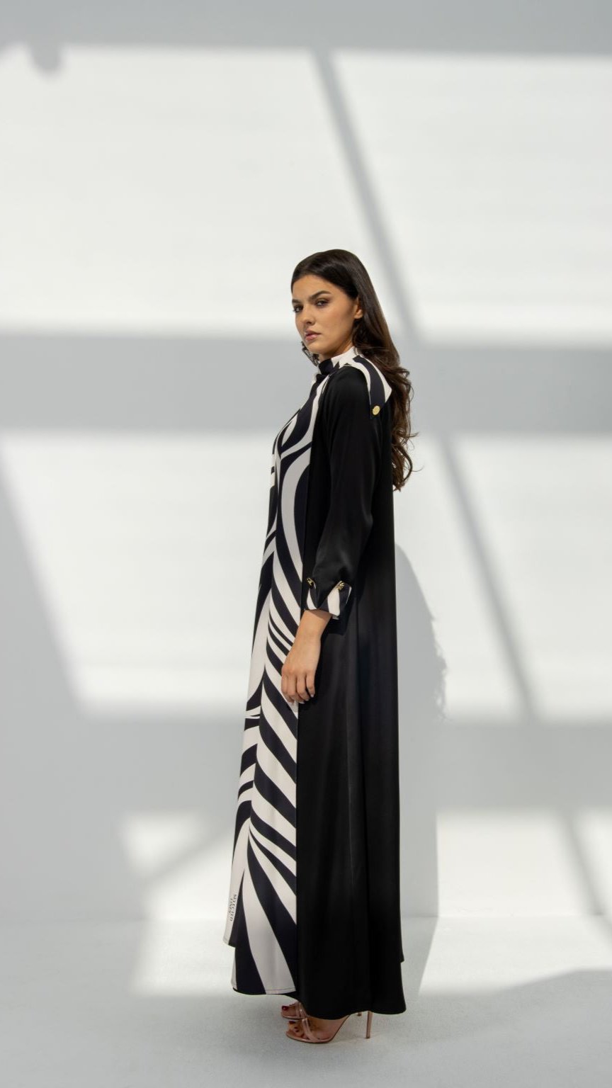 Side profile of Zebra Abaya highlighting the signature Z printed material and two engraved logo buttons | Selected Lines