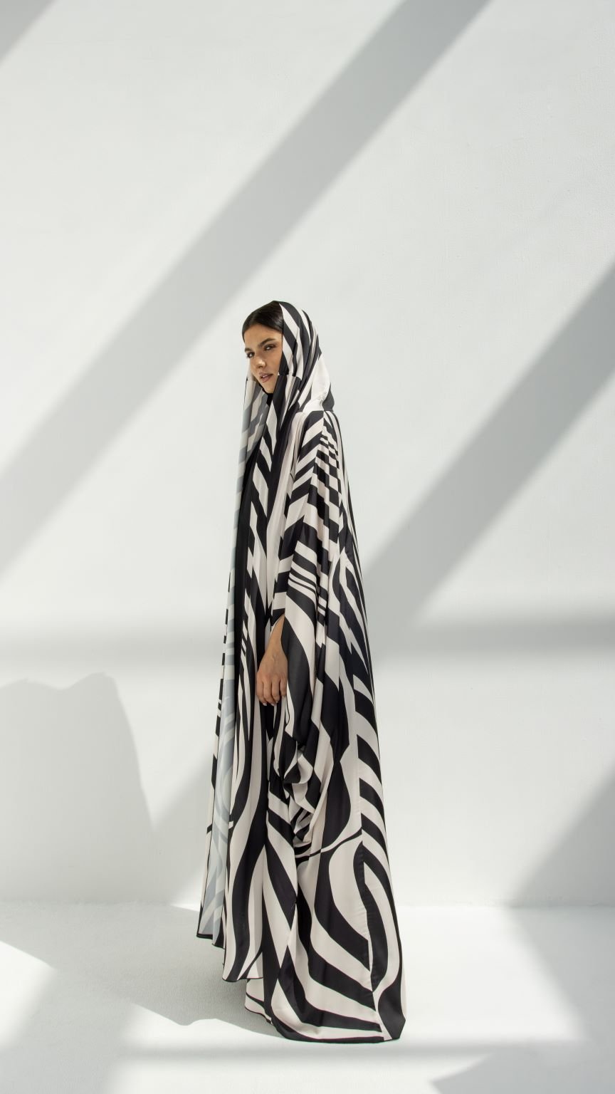 Side profile of Zebra-Hoodie Abaya highlighting the hoodie and SLC printed fabric | Selected Lines