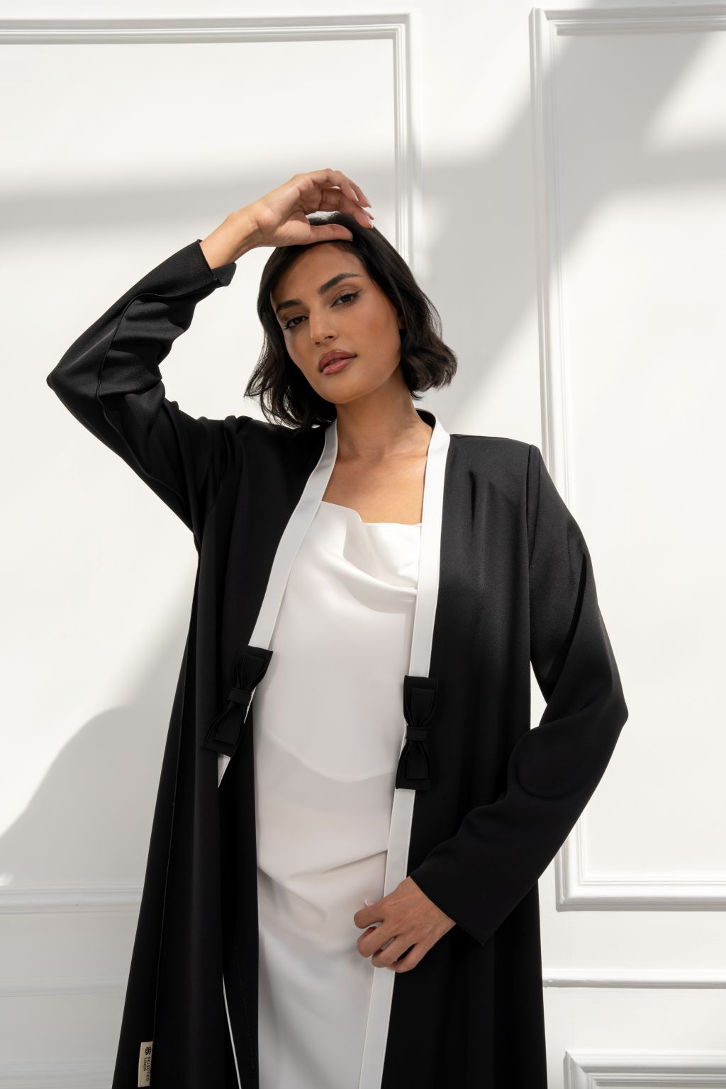 Woman wearing a stylish burgundy coat in luxury new arrivals fashion collection