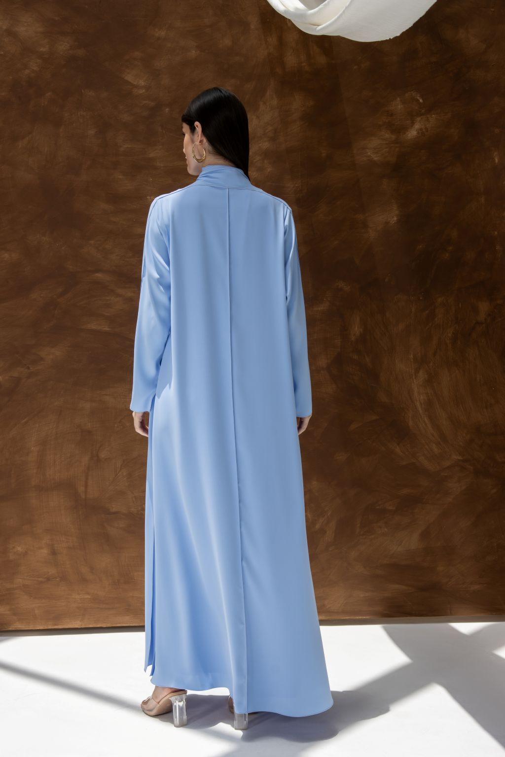 Selected Lines light blue abaya styled as a classic evening dress for special occasions with long sleeves and full length