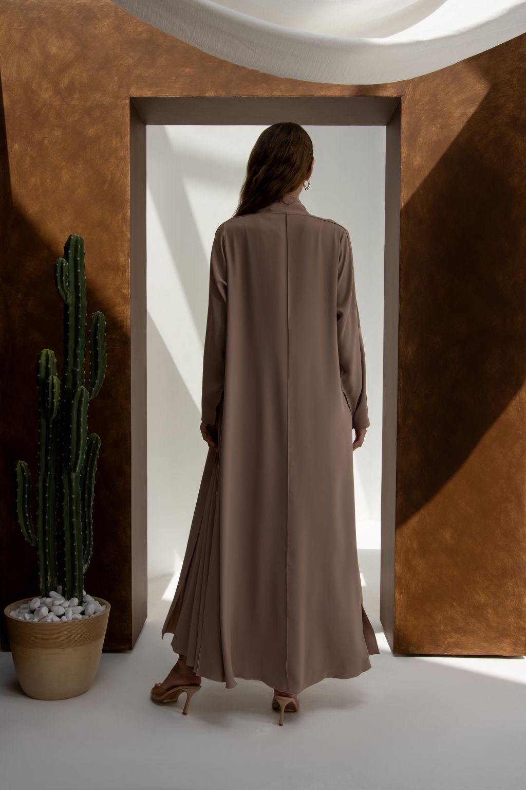 Selected Lines taupe abaya shown from back as classic evening dress for special occasions