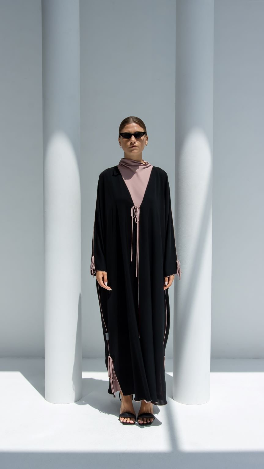 Stylish Bahraini ribbon abaya in black with pink accents and elegant design for versatile fashion