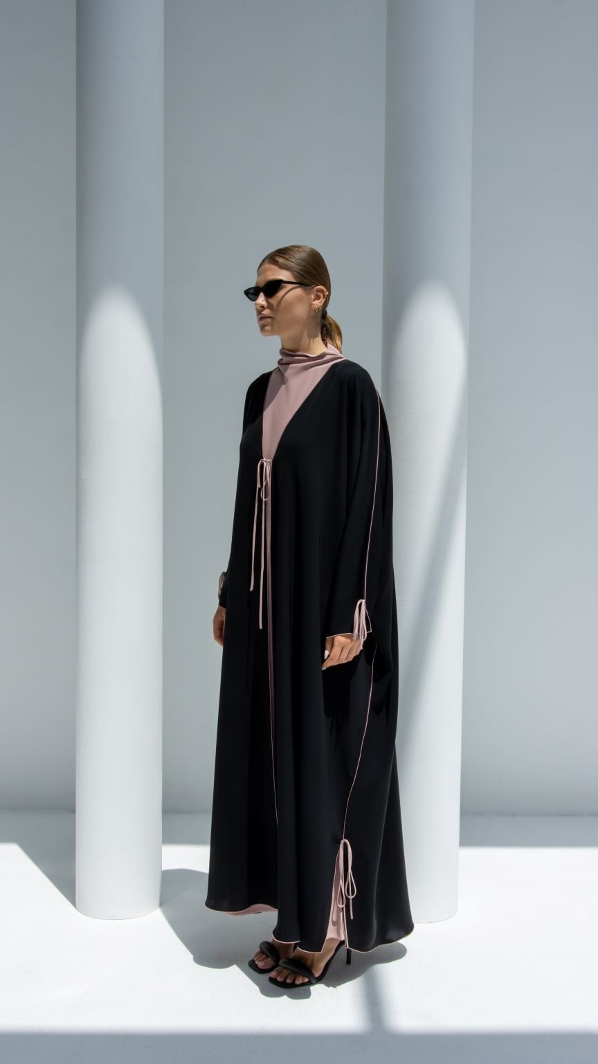 Elegant Bahraini ribbon abaya in black with stylish ties, perfect for modern modest fashion.