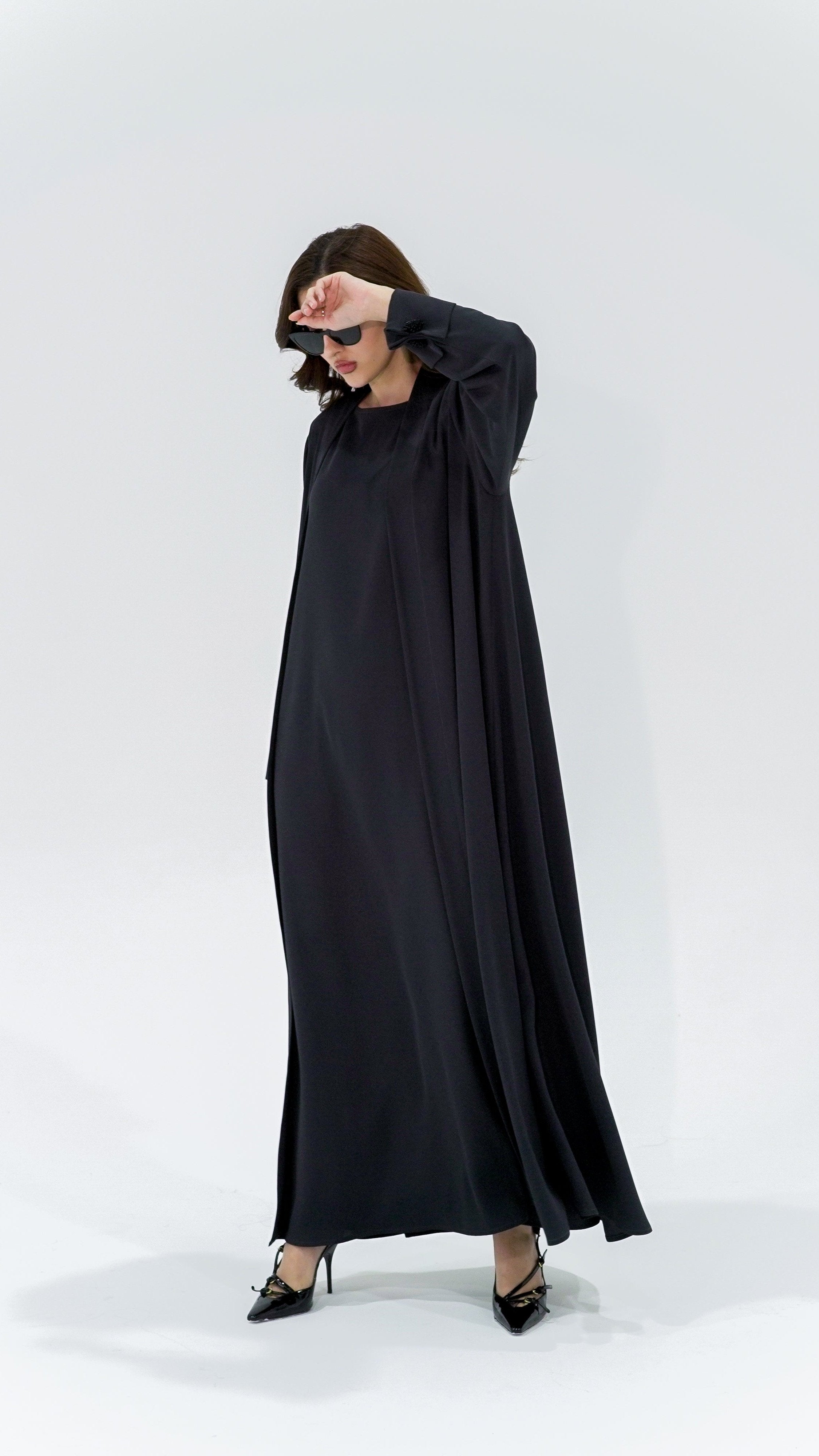 Charcoal pearl sleeve abaya in black worn by woman with black heels by Selected Lines