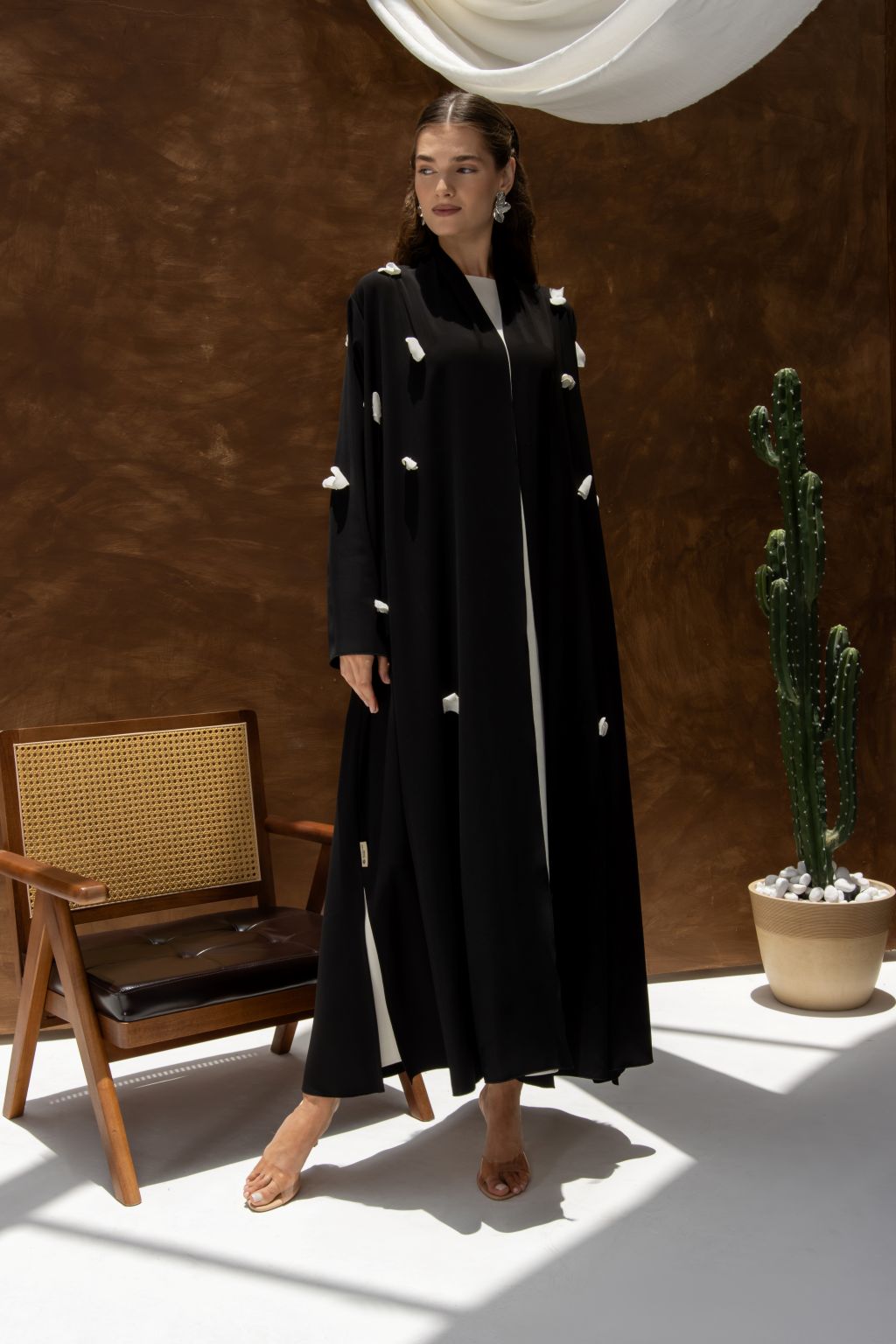 Selected Lines black designer abaya handcrafted details with white floral embellishments and long sleeves