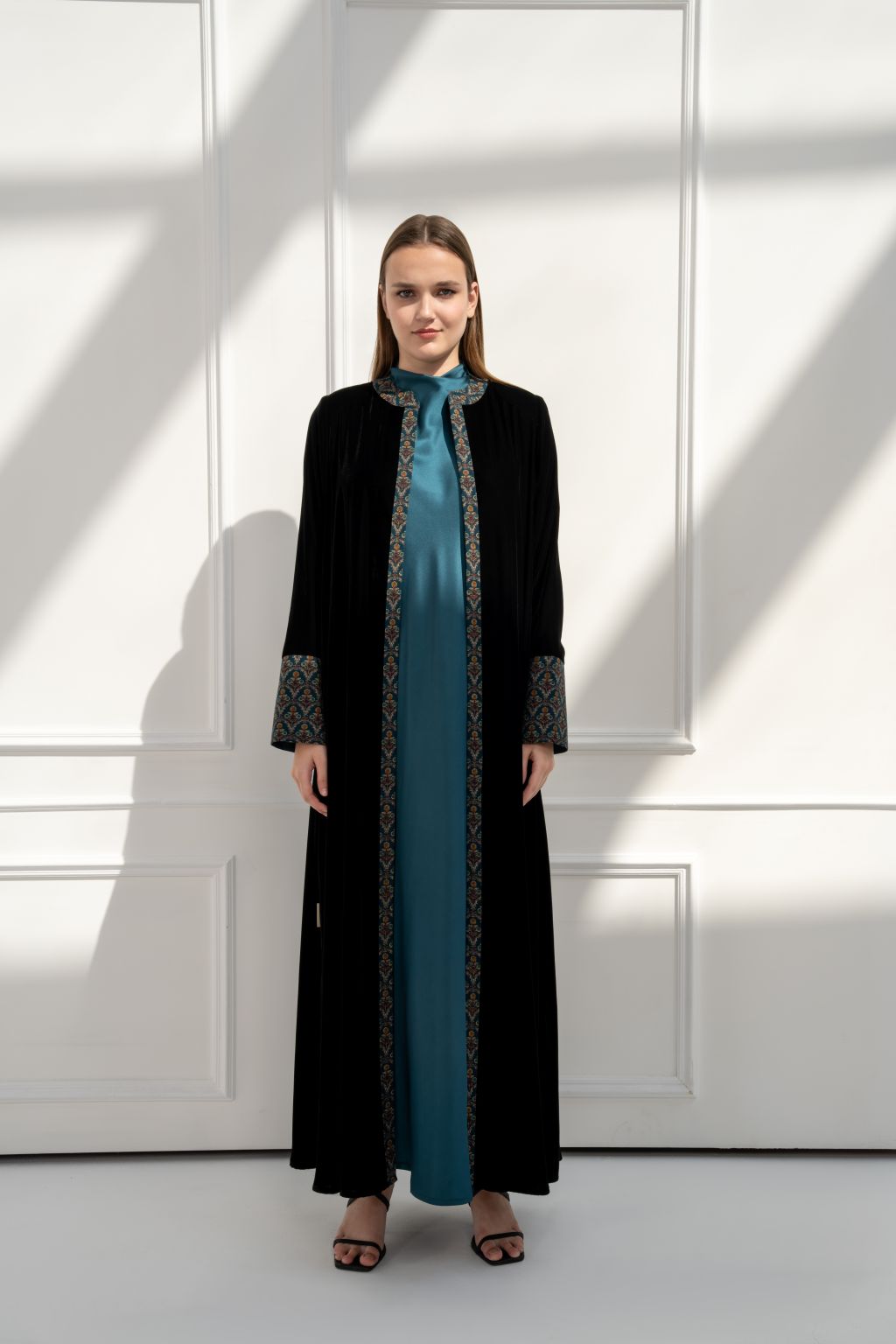 Selected Lines Black Abaya with teal inner lining and ornate detailing, perfect designer coat for special occasions.