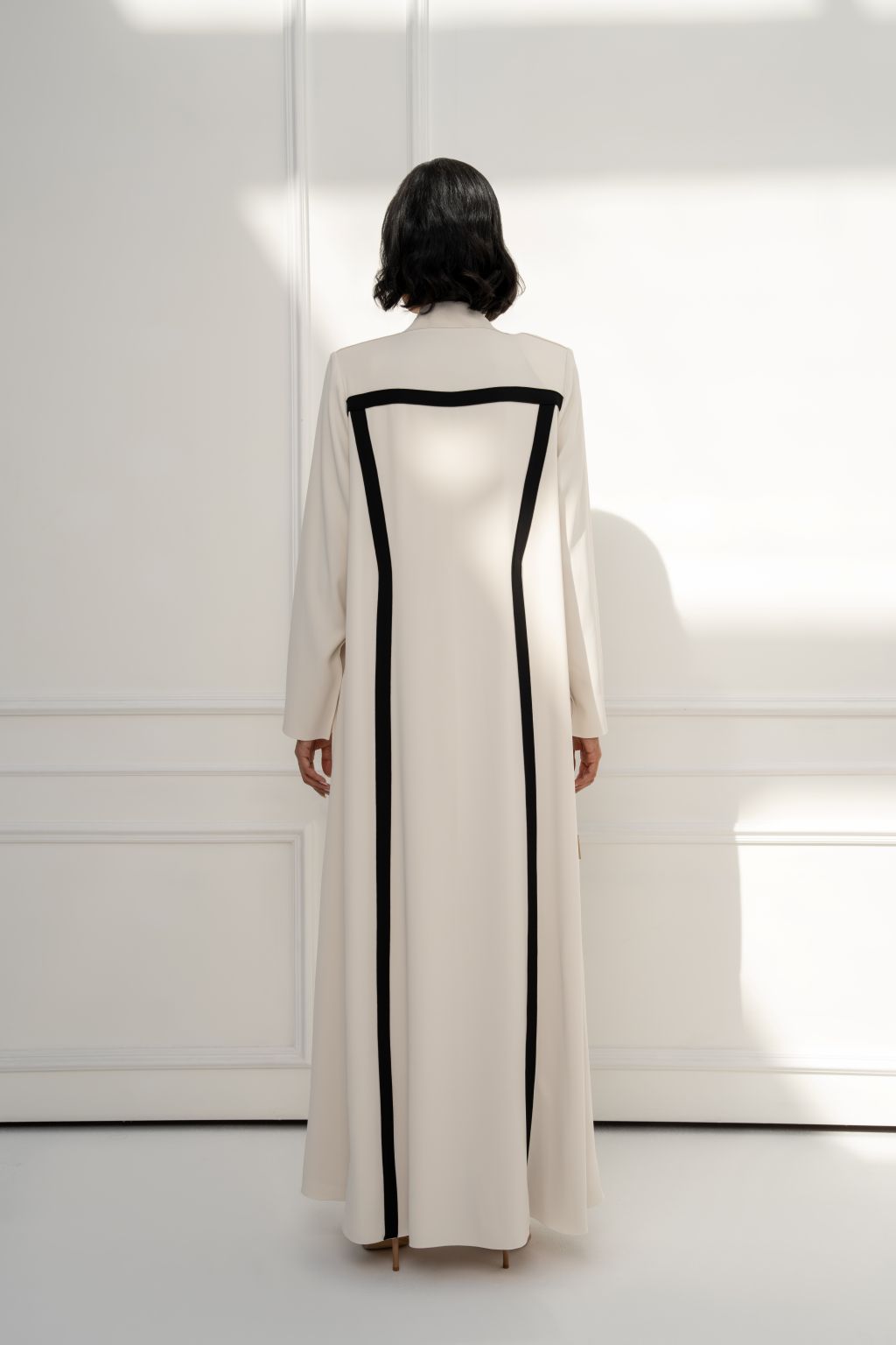 Selected Lines Cream Abaya with Black Trim, elegant designer evening wear for women.