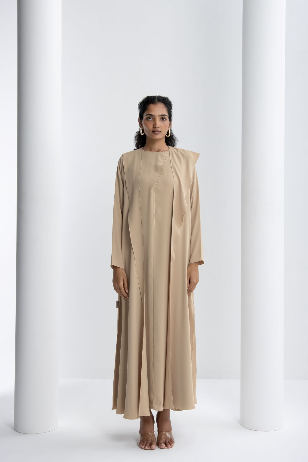 Elegant Abaya for women in light beige with a stylish minimalist design and flowing silhouette