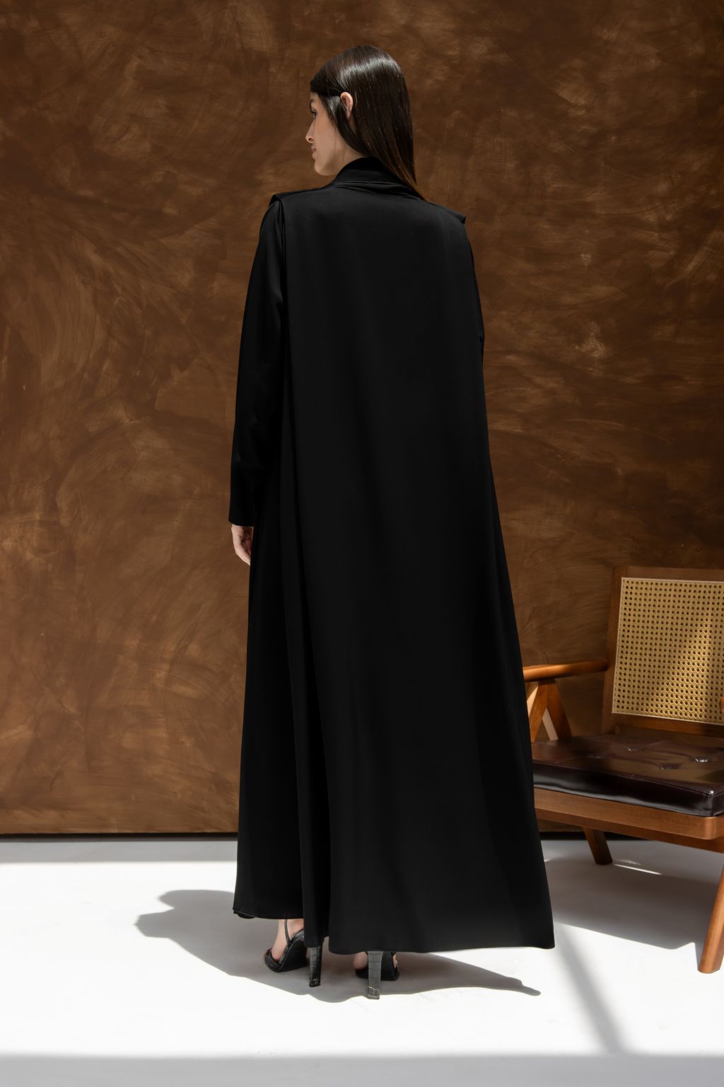 Elegant black abaya with long sleeves and flowing design for stylish modest wear